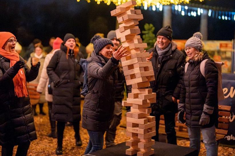 Guests playing giant Jenga under fairy lights
